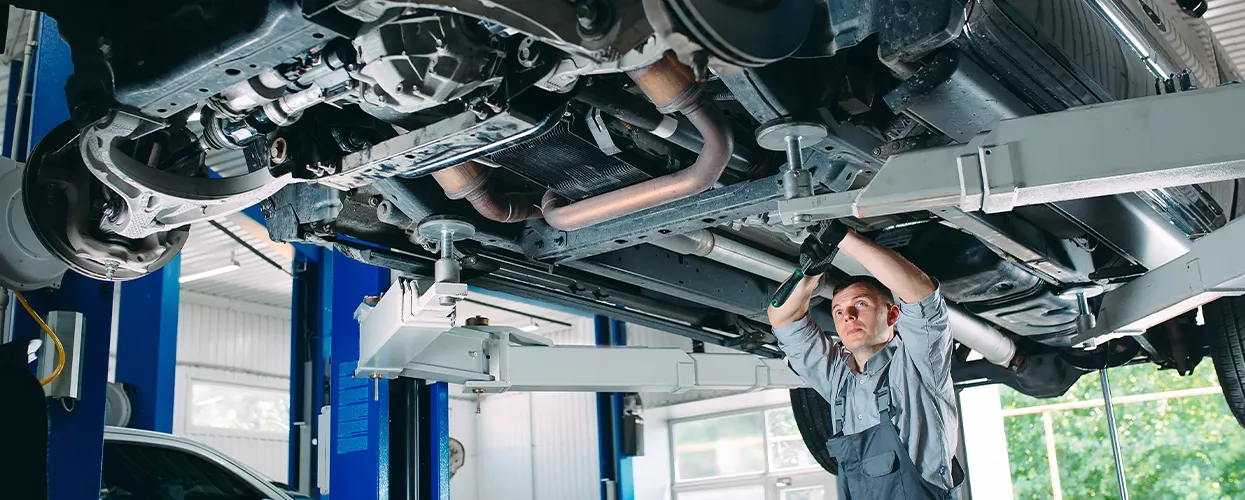 Mechanic working under a vehicle