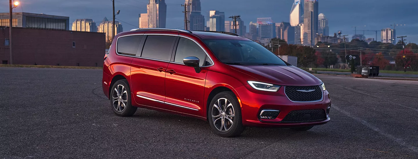 Front view of the 2026 Chrysler Pacifica parked in front of a city skyline