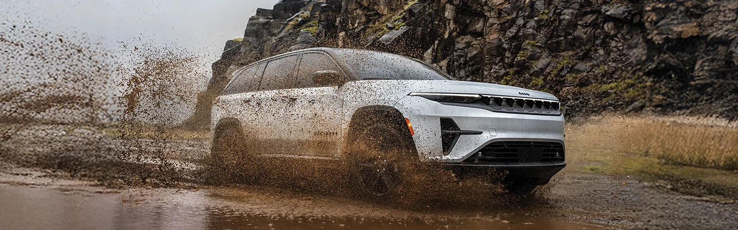 white 2025 Wagoneer S driving in mud