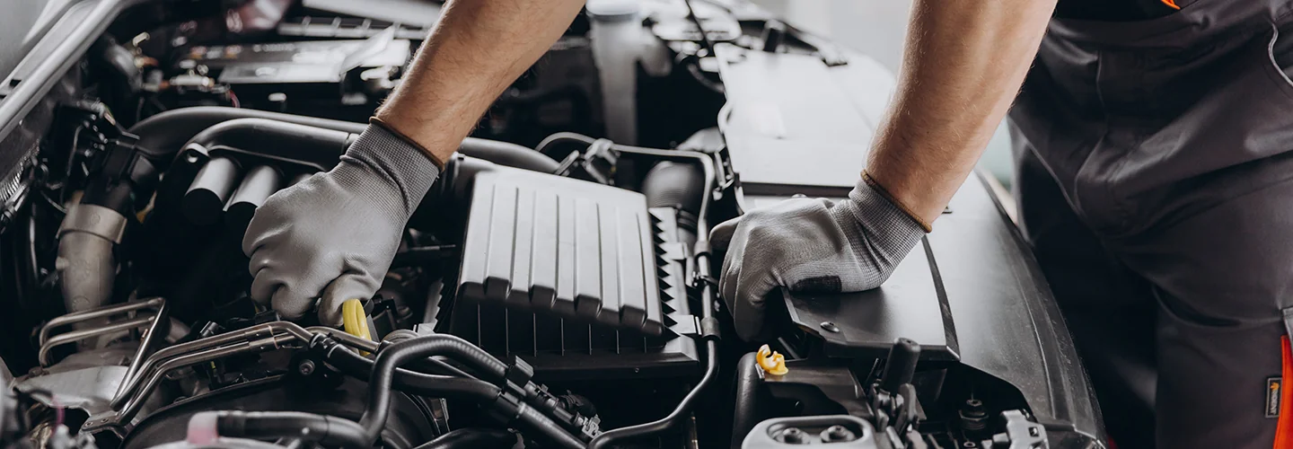 view auto mechanic hands working on a car