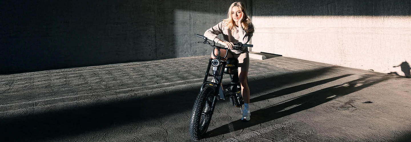 A women sitting on a VinFast DrgnFly eBike in a parking lot