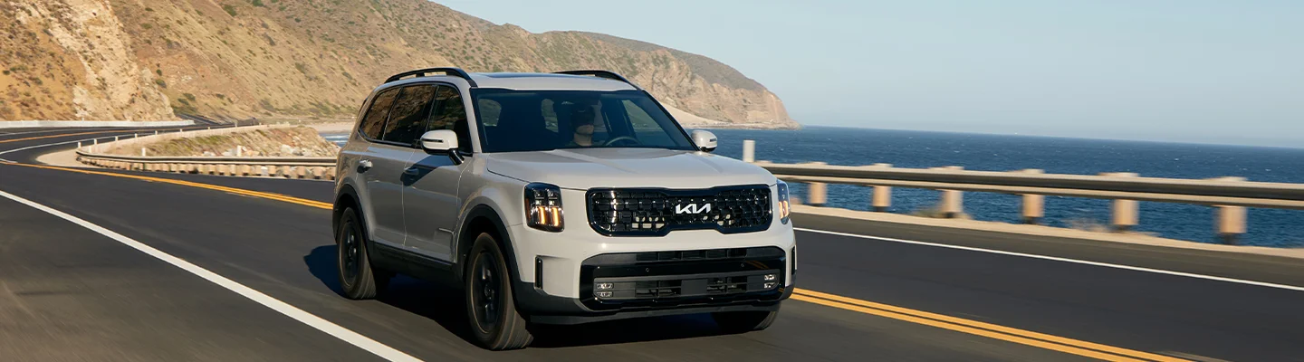 2024 Kia Telluride driving on a seaside road