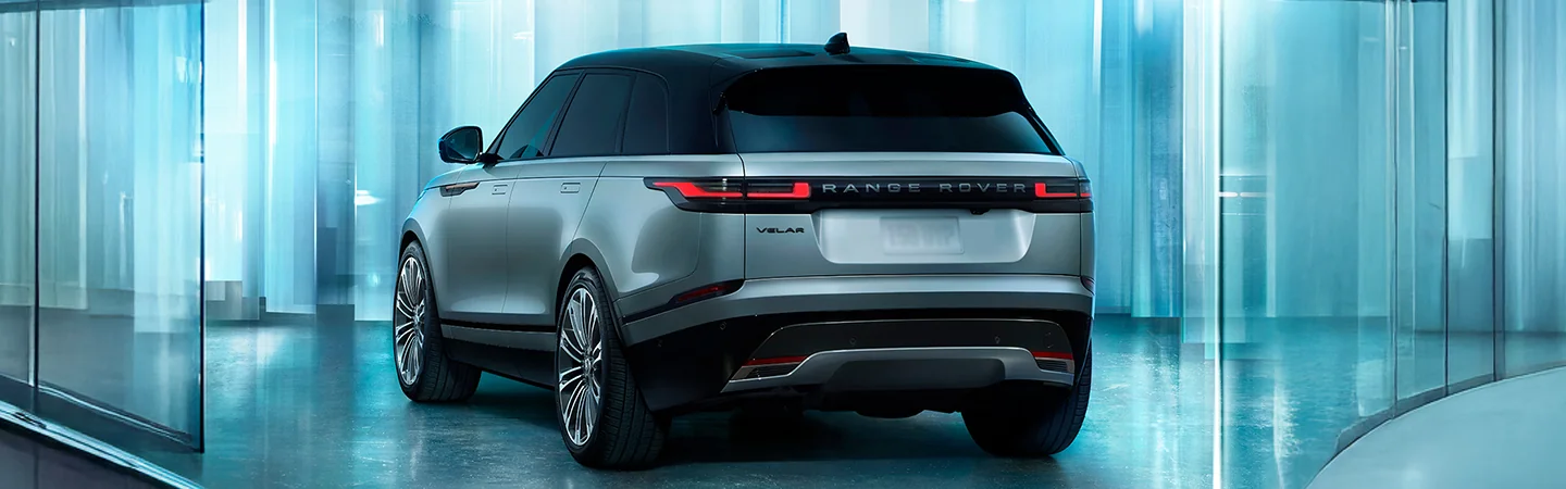 Rear view of the 2026 Range Rover Velar parked in a reflective room