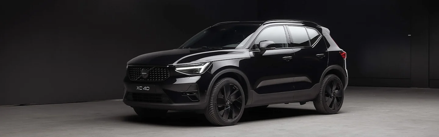 Front view of a 2026 Volvo XC40 parked in a darkly lit parking garage