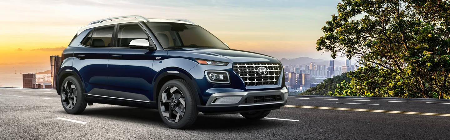 blue 2025 Hyundai Venue driving on highway