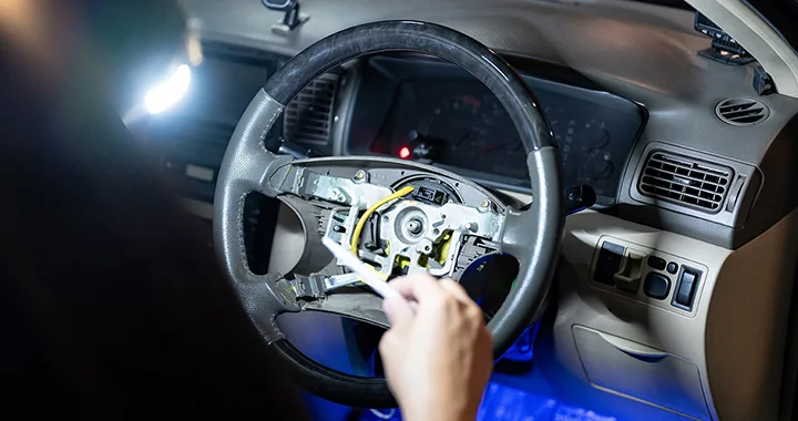 auto mechanic working on interior of car at Douglass Subaru in Waco, TX