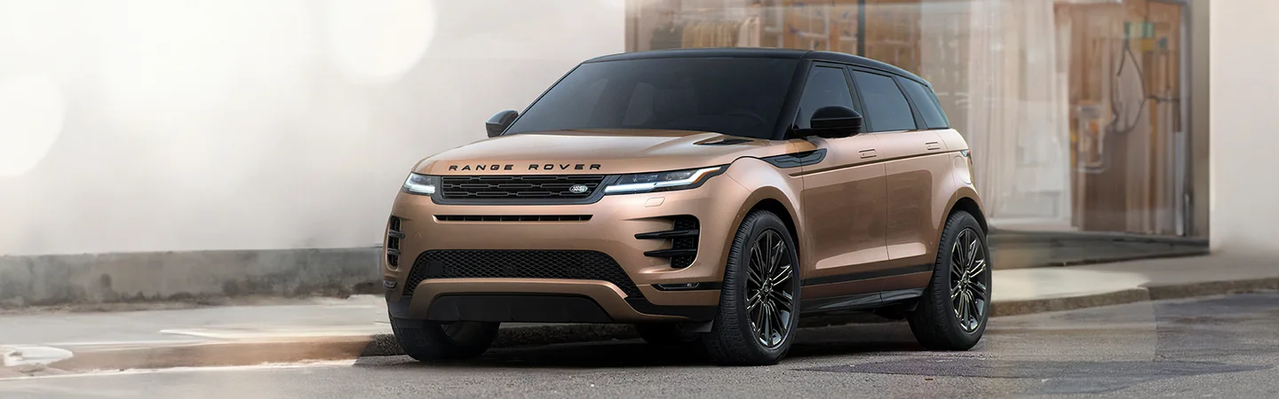 Front view of a praked copper 2026 Range Rover Evoque on a city street