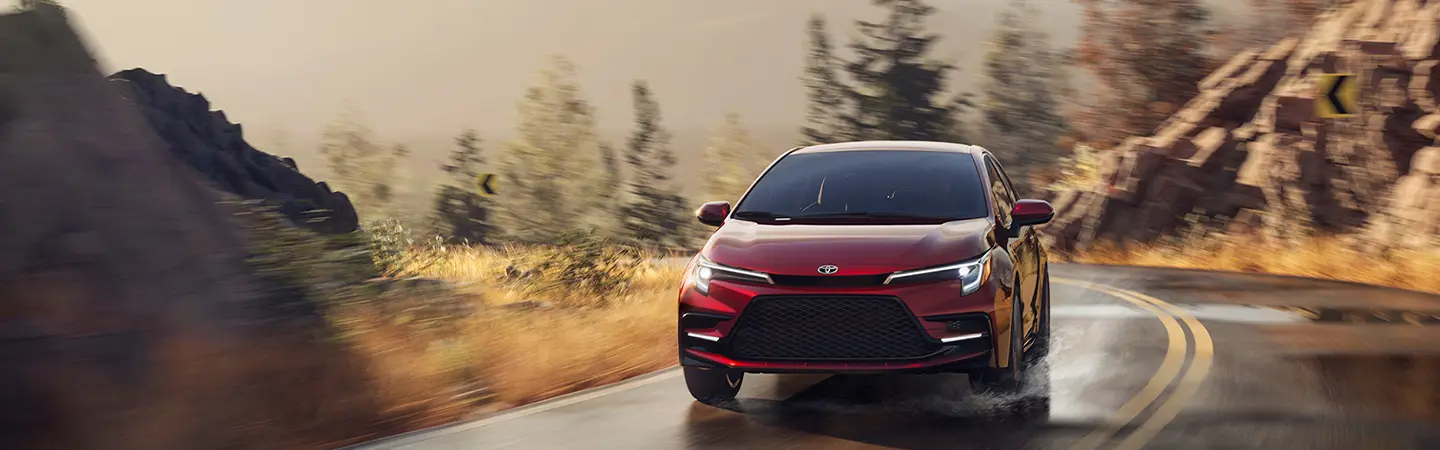 2026 Toyota Corolla in red taking a wet curve