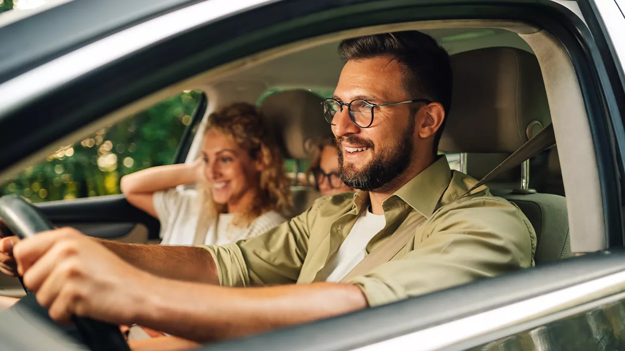 Family driving in a new Subaru