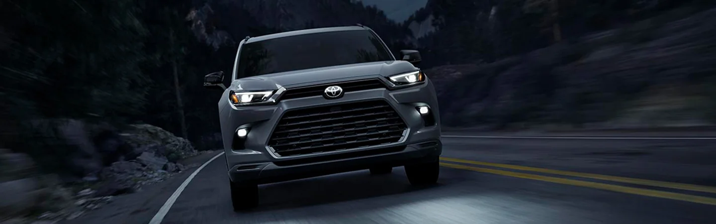 Gray 2025 Toyota Grand Highlander driving down the highway