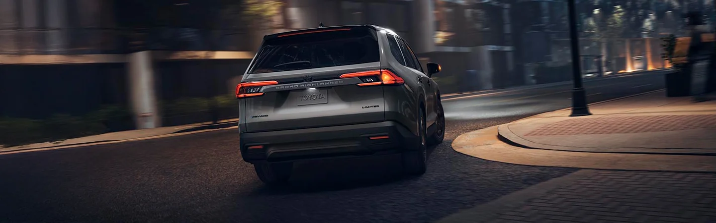 Gray 2025 Toyota Grand Highlander driving in a city