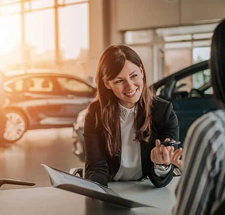 Woman with keys sitting in car