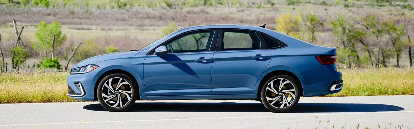 Side view of a parked blue 2024 Volkswagen Jetta