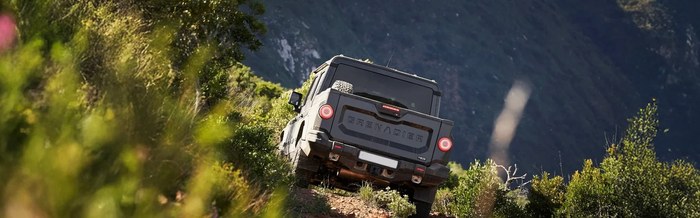 2024 INEOS Grenadier vs Jeep Wrangler black back view