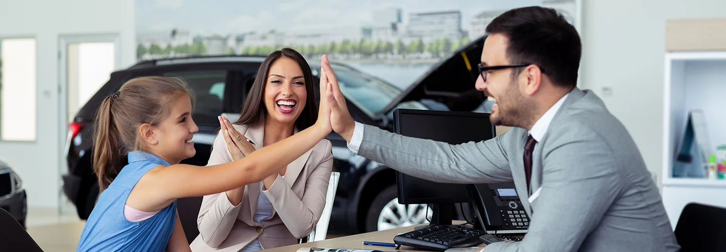 playin hi-five in car showroom