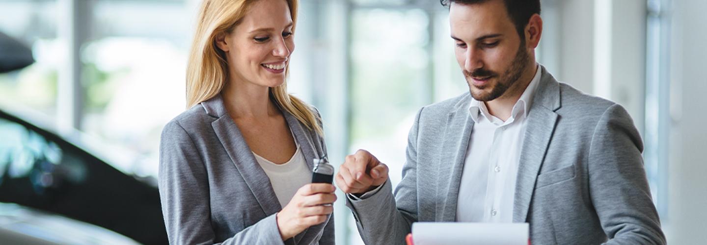 man and woman looking at a paper