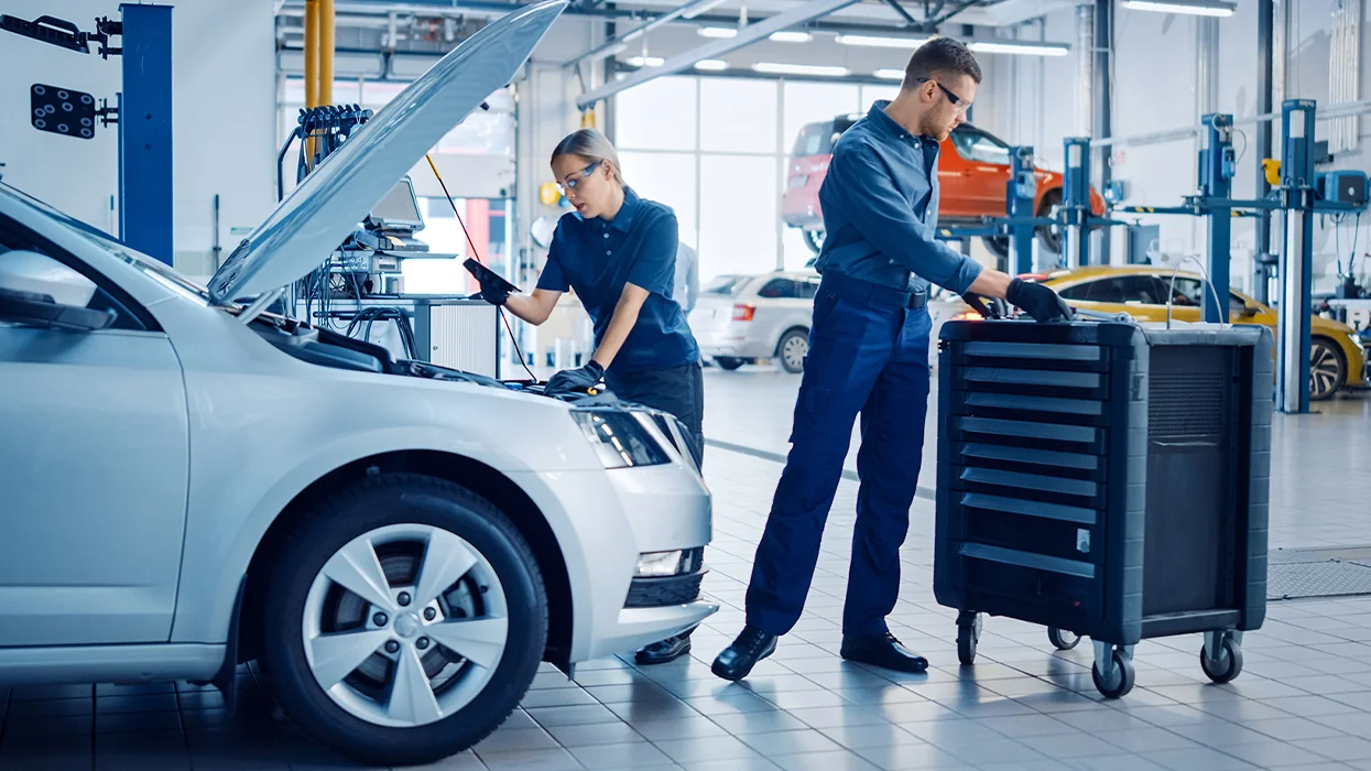 auto mechanics in the service bay working on car