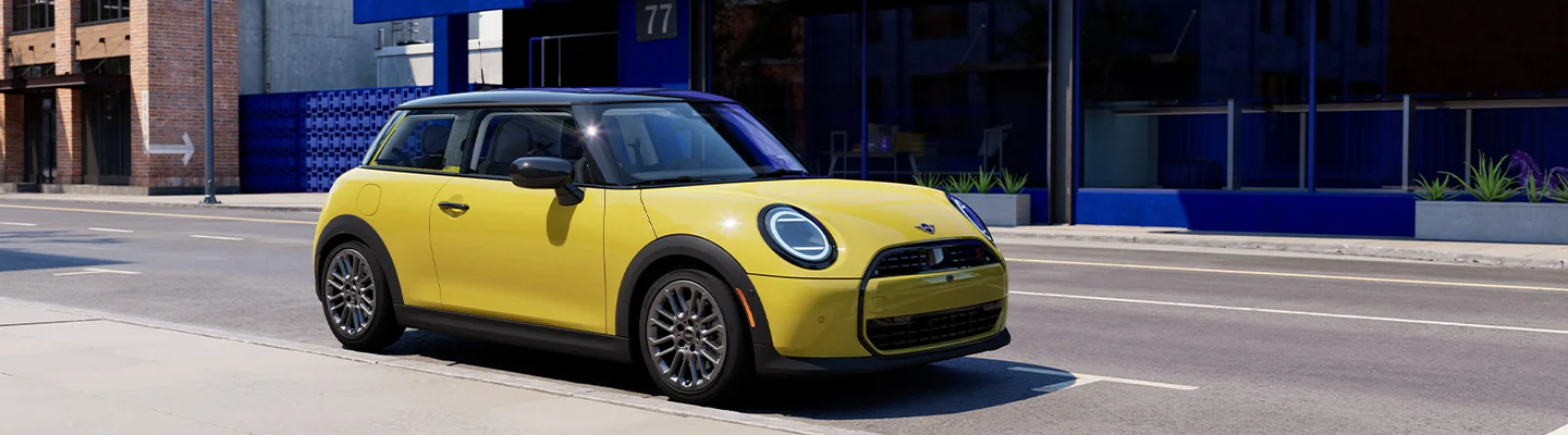 Yellow MINI driving in the city