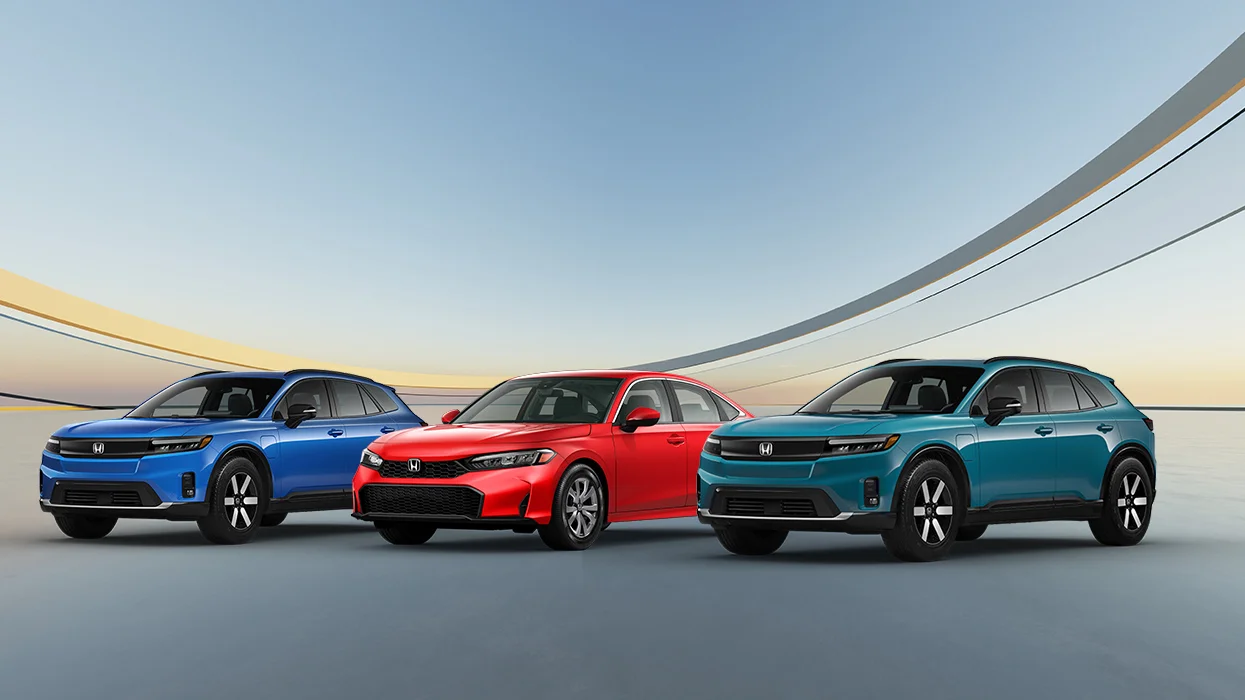 salesman showing a car to a man and woman