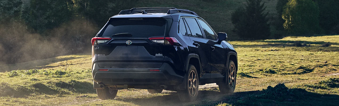 2025 Hyundai Tucson rear view driving on dirt road