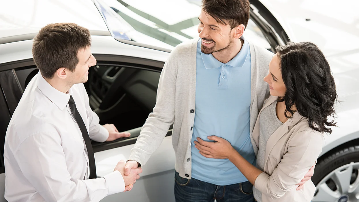 Finance person talking to customers about lease vs finance payments