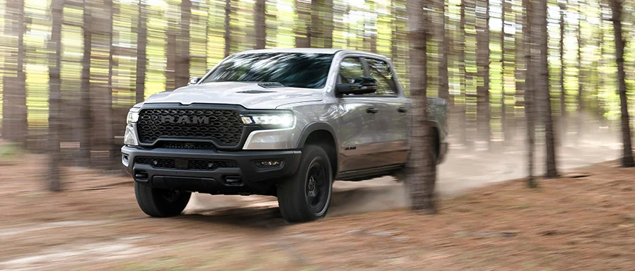 A 2026 RAM driving thought the woods