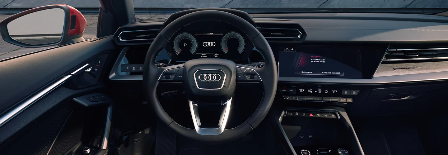 Interior view of the driver seat and dashboard of a 2025 Audi A3