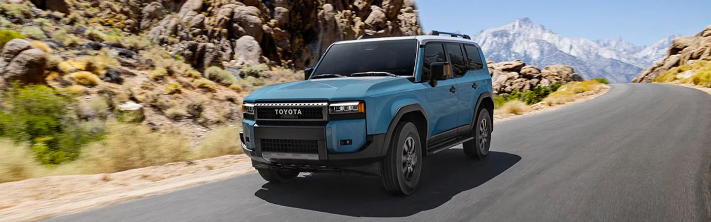 Blue 2025 Toyota Land Cruiser driving on the highway