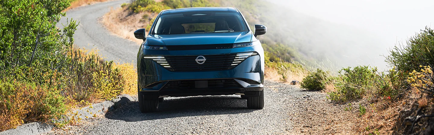 The 2025 Nissan Murano blue color car driving on a winding road