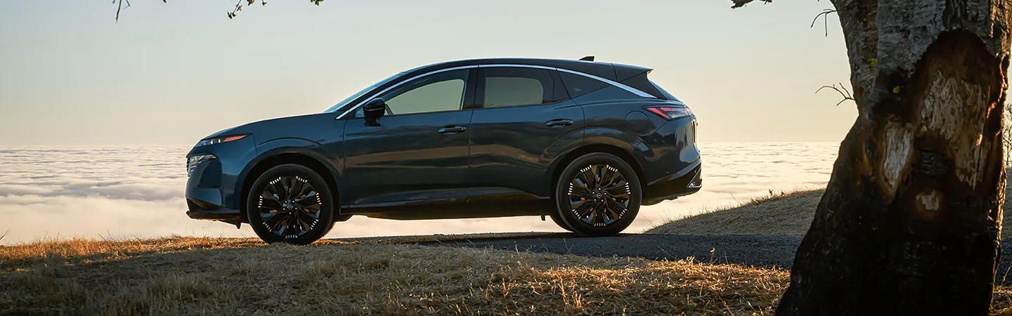 The 2025 Nissan Murano blue color car parked on a hilltop road