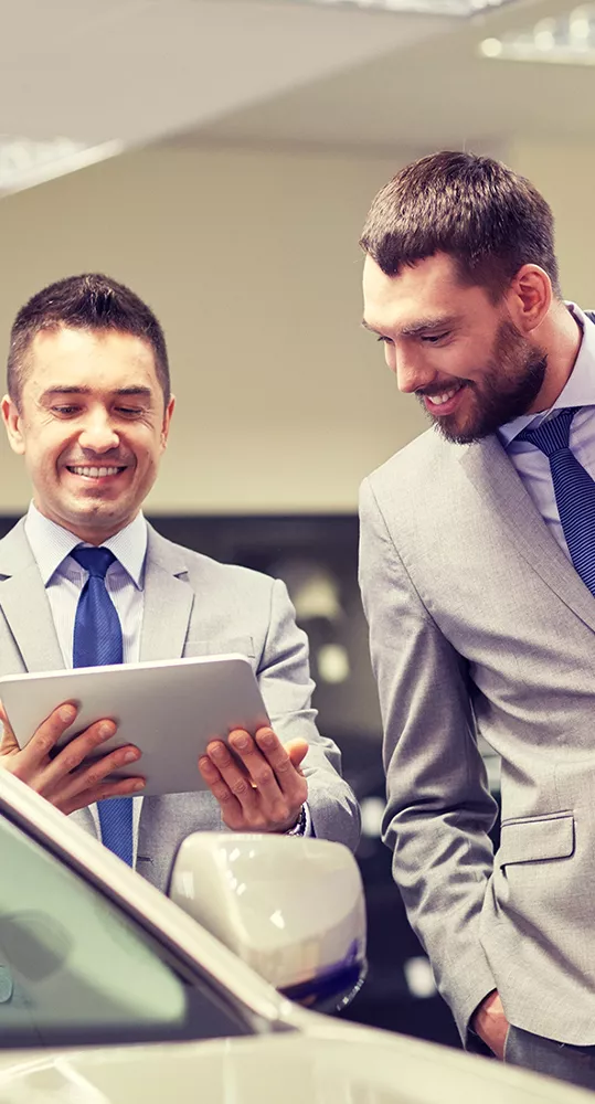 Two people looking at a tablet