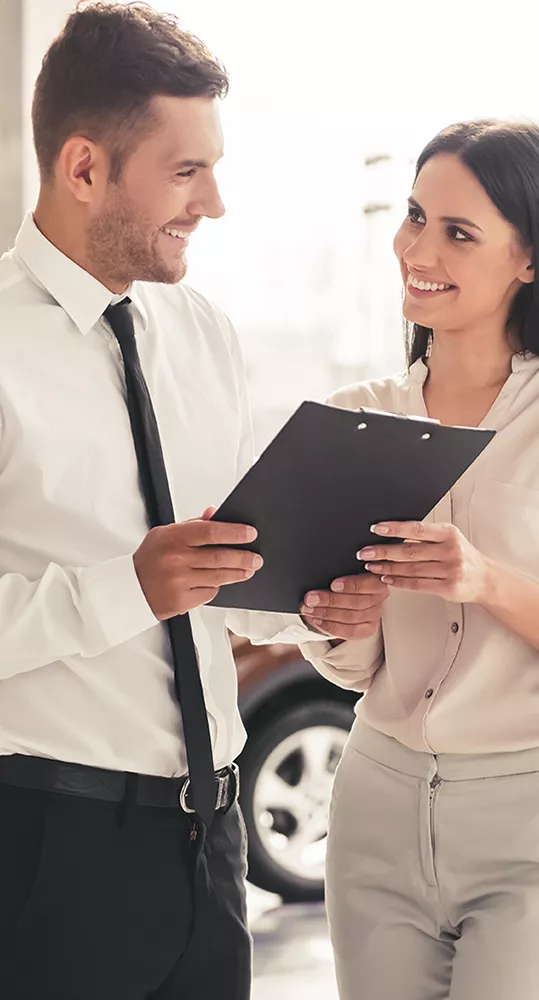 Two people looking at a clipboard