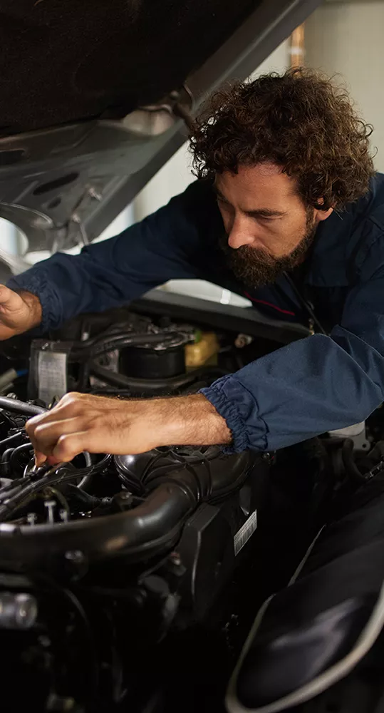 Technician servicing a vehicle