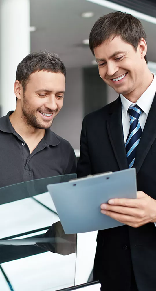 Sales person talking to a customer about the details of a new car at Jaguar St. Petersburg in St. Petersburg, FL