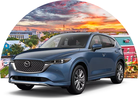 Mazda parked in front of cityscape