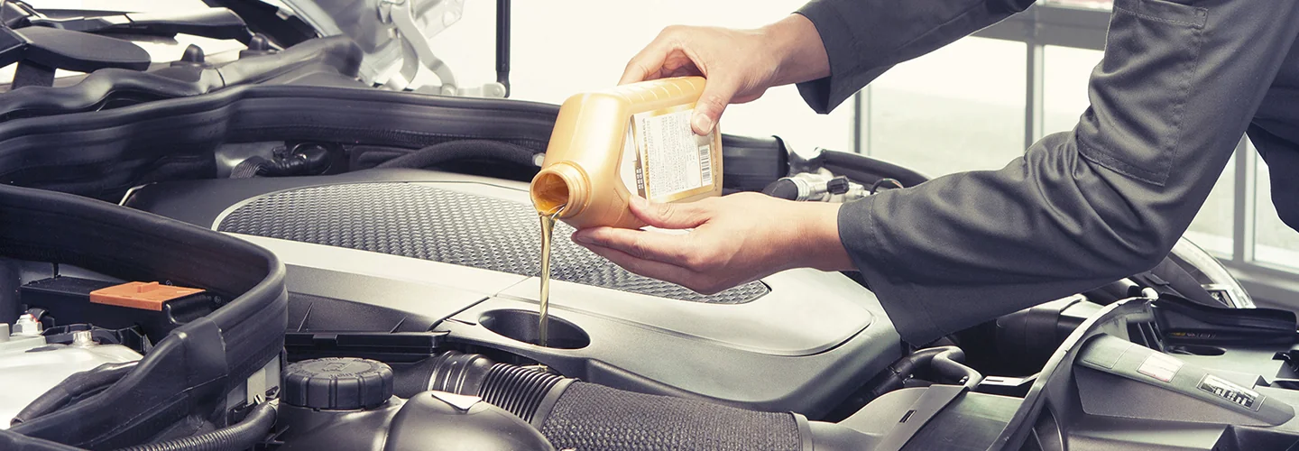 pouring oil in car