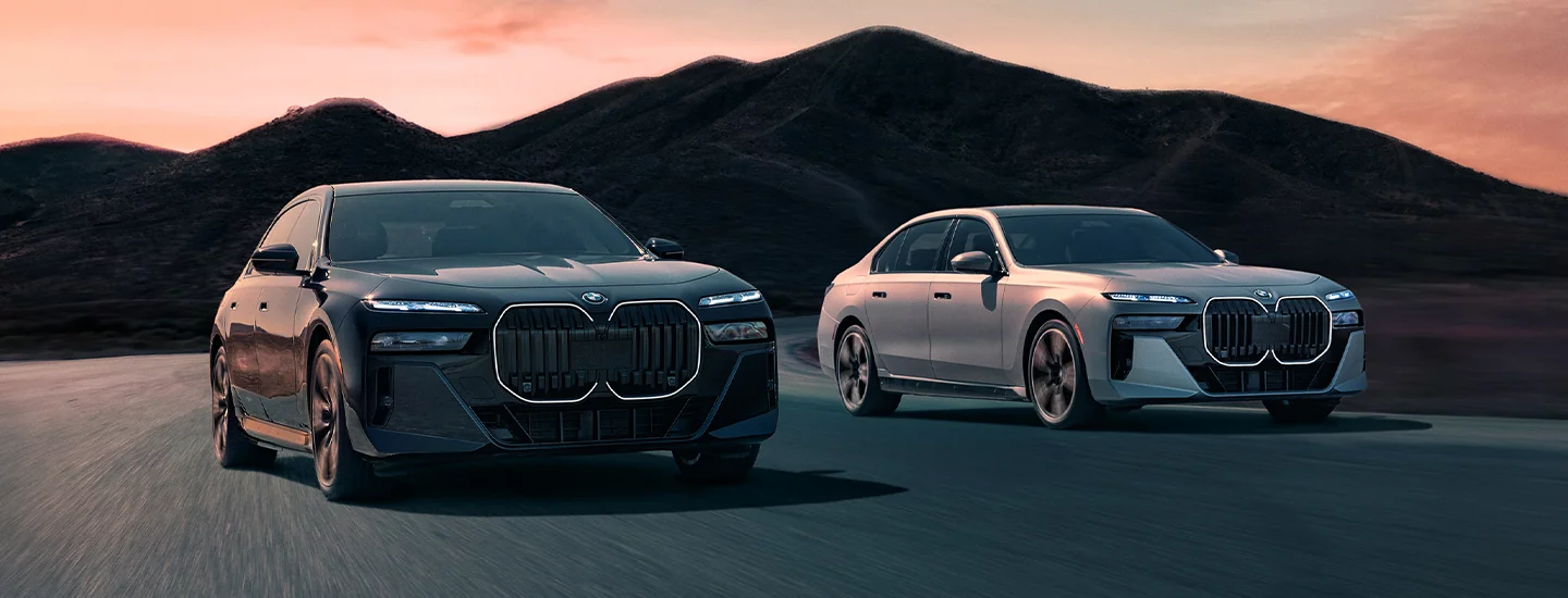 Two 2025 BMW i7 driving side by side