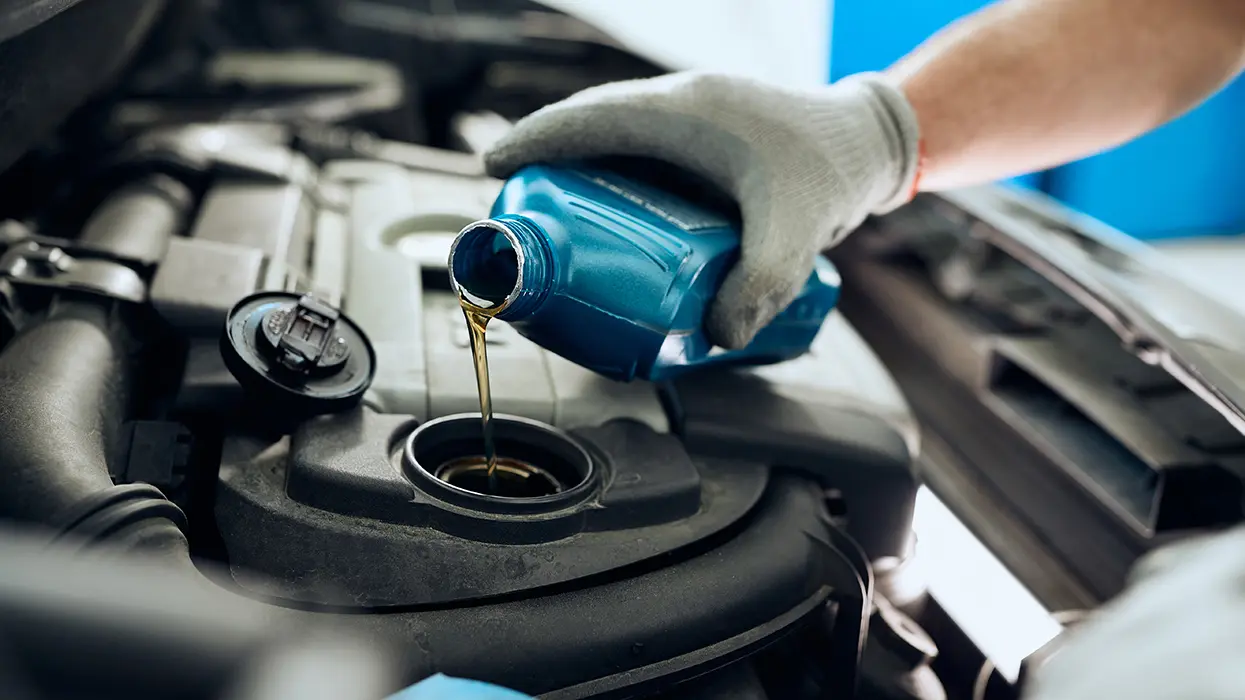 pouring oil into engine