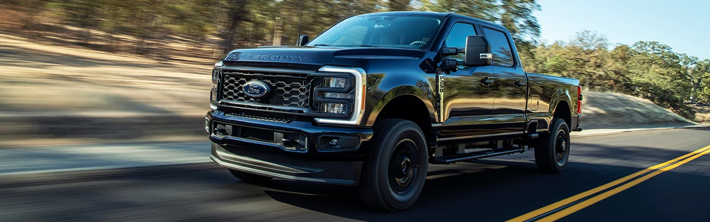 black 2025 Ford F-250 Super Duty driving on road
