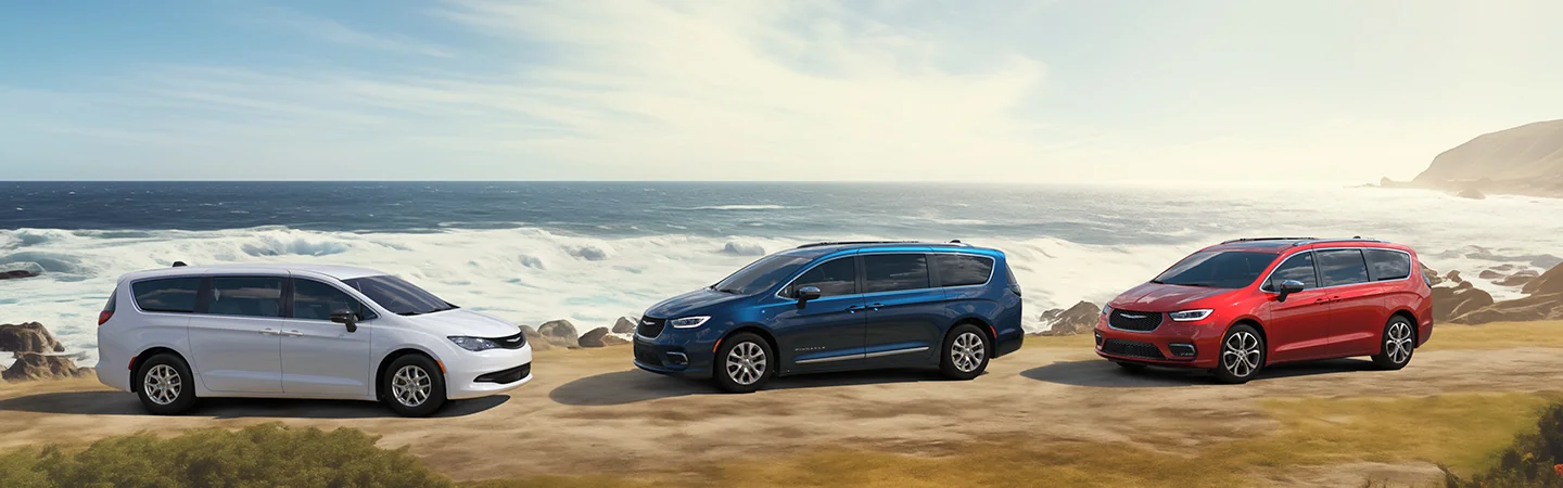 2025 Chrysler Pacifica Plug-In Hybrid Blue red with car park on beach