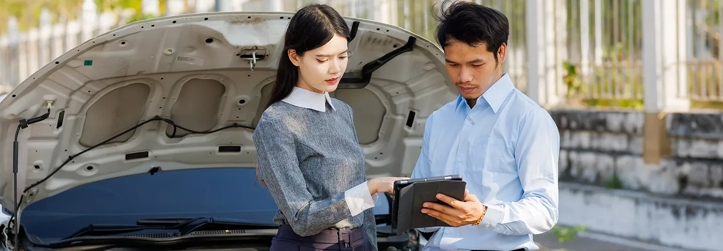 Service mechanic showing a customer a tablet