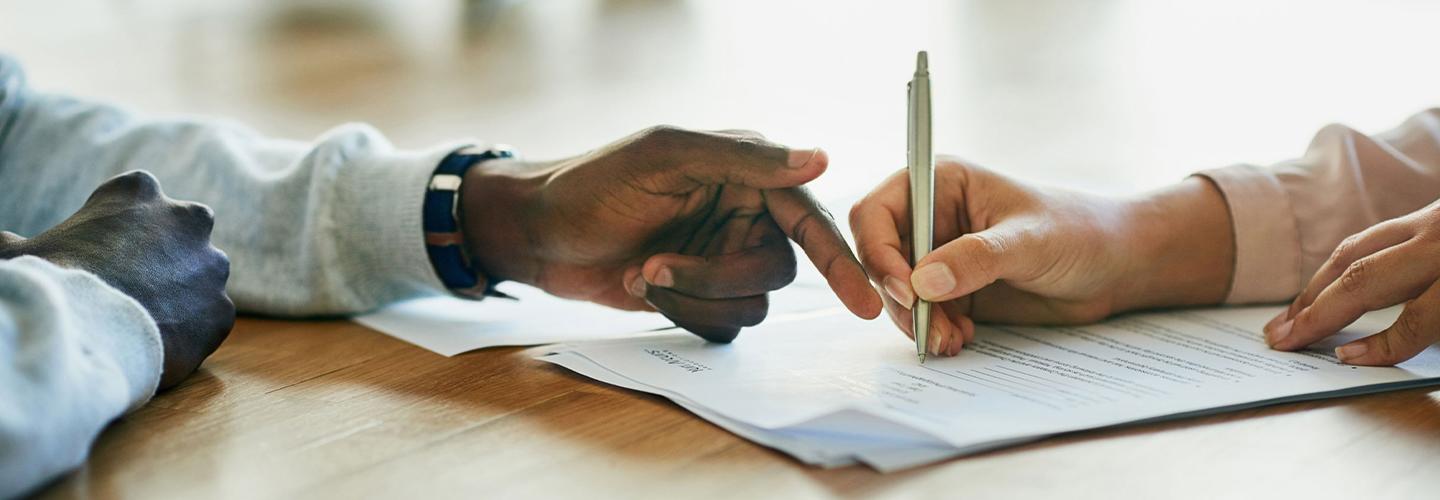 A customer and financial advisor signing lease paperwork