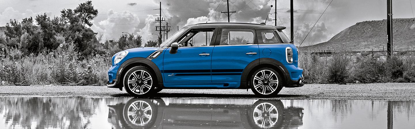 Side profile of a parked blue MINI Countryman