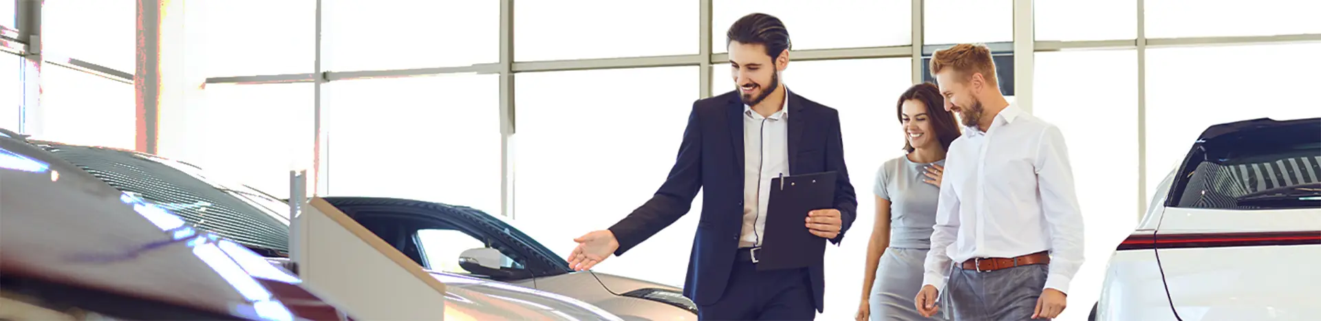 Sales man talking to customers about a new car