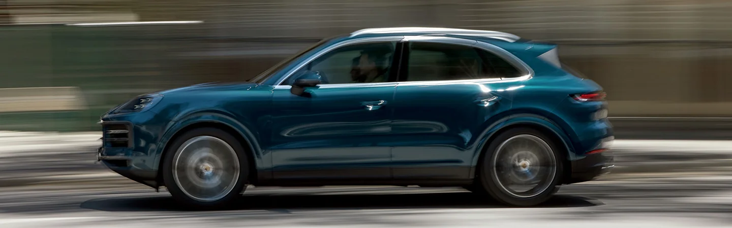 driver side view of a 2025 Porsche Cayenne Coupe Base in motion