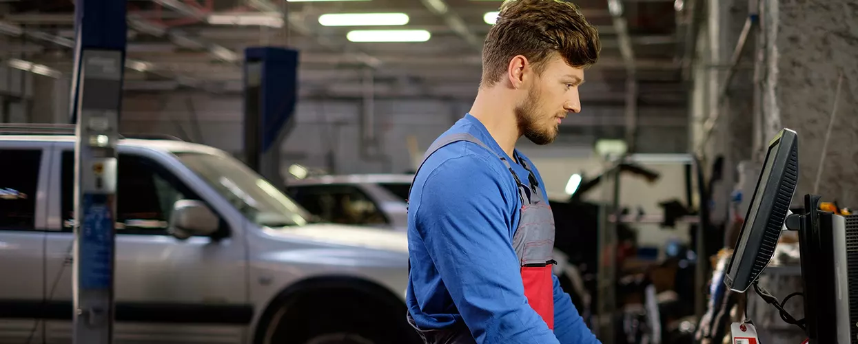 Service mechanic running a diagnostic on a vehicle