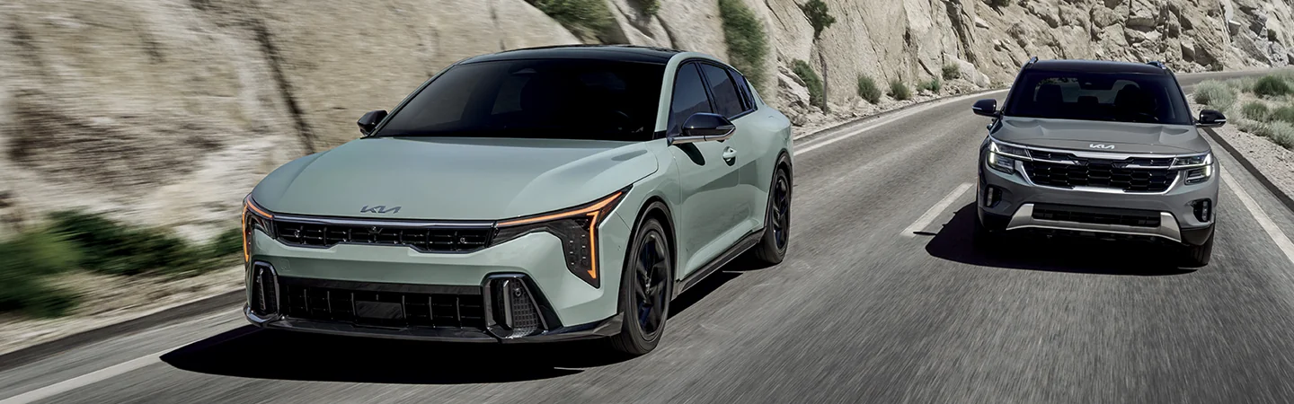 2 2025 Kia K4 driving on a mountain side road