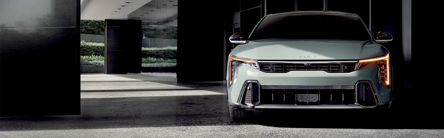 Front view of a 2025 Kia K4 parked under a building