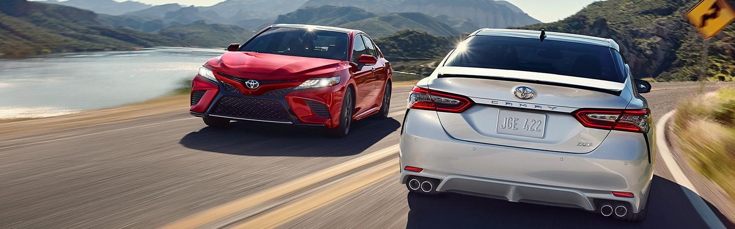 Two 2020 Toyota Camry vehicles driving on the road
