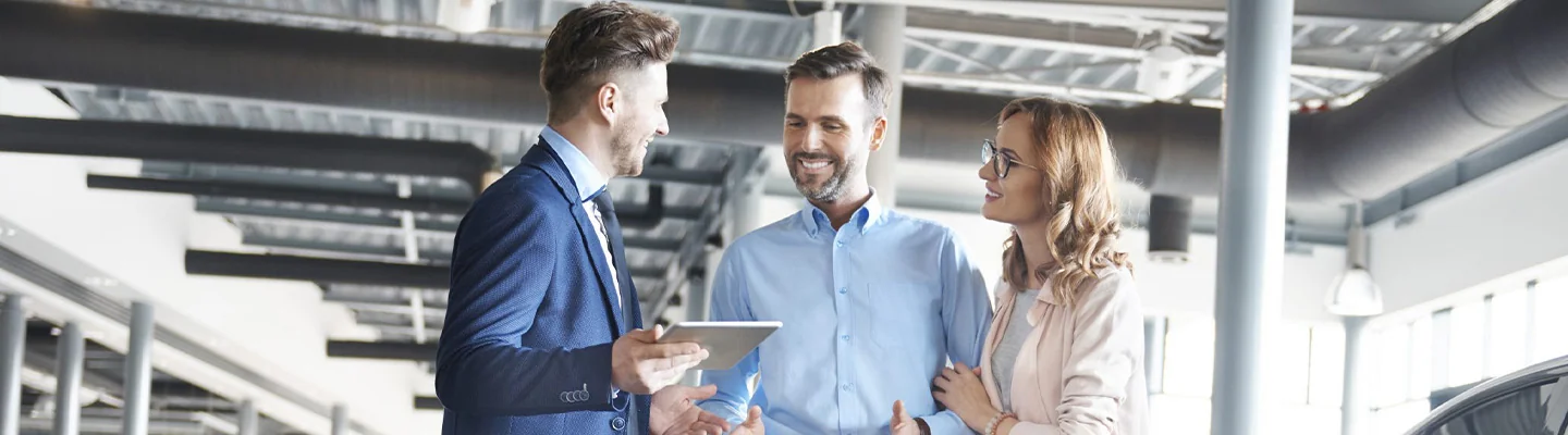 Sales person helping customers go over financing deals